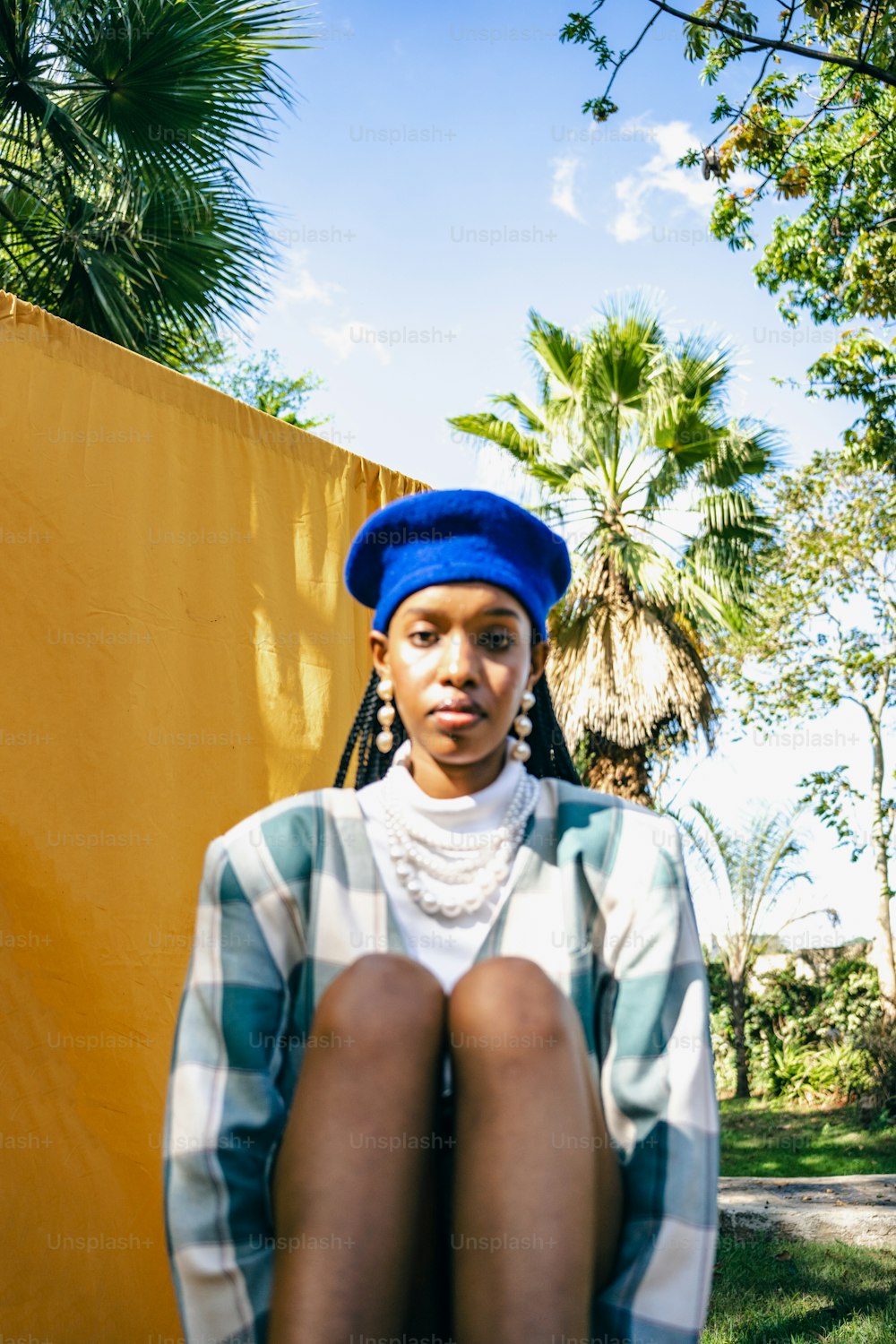 a woman with a blue hat sitting on a bench