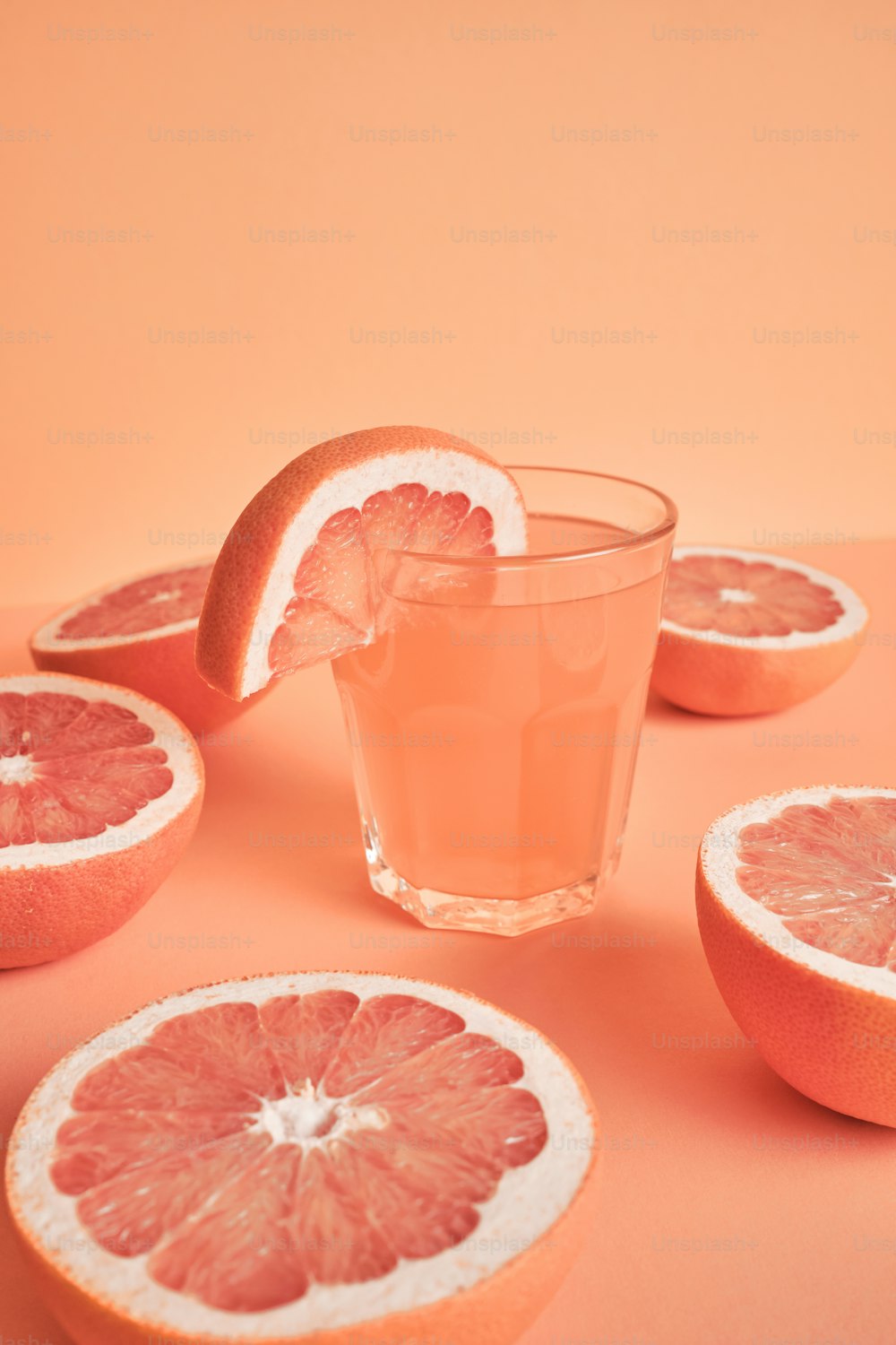grapefruits and a glass of water on a table
