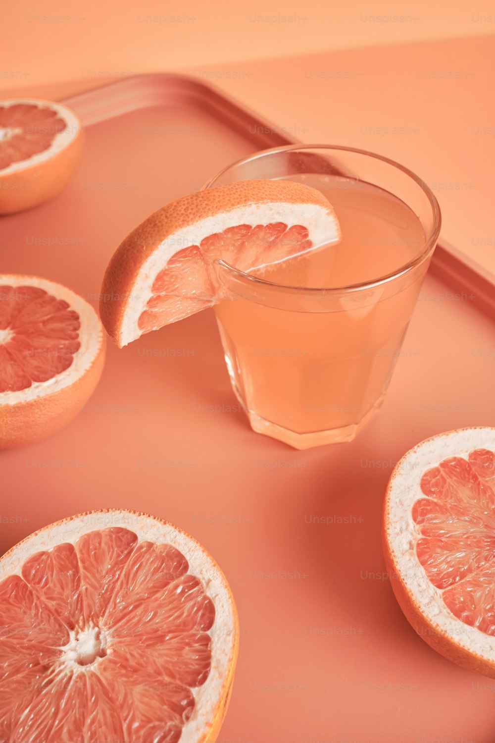 grapefruit slices and a glass of water on a tray
