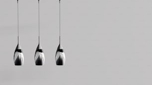 a group of three black and white hanging lights