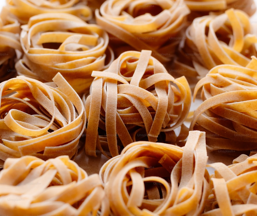 a pile of uncooked pasta sitting on top of a table