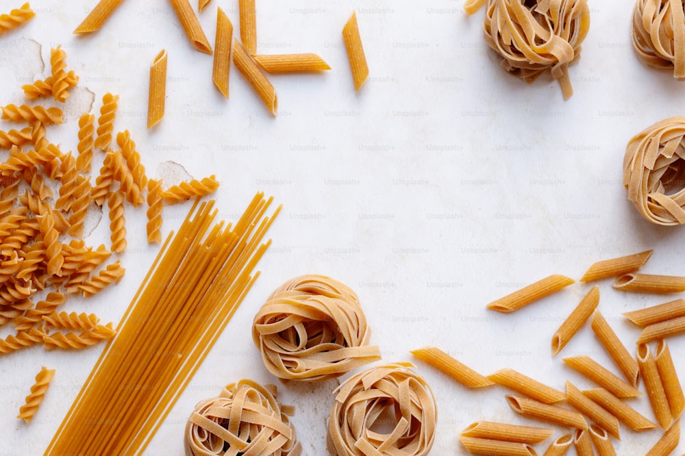 a table topped with lots of different types of pasta