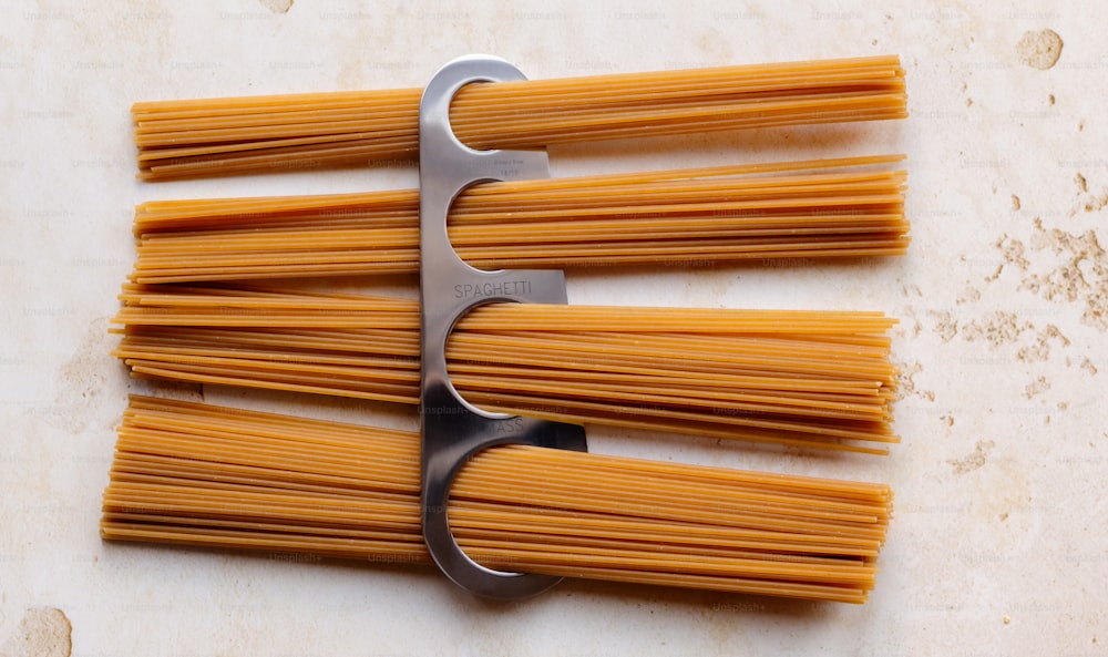 a bunch of pasta being cut with a scissor