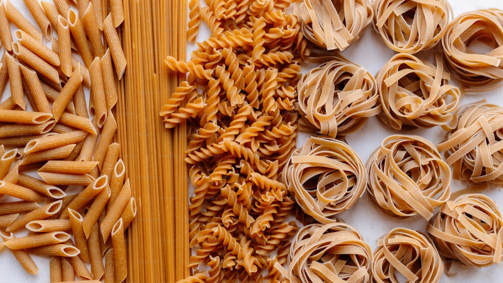 a table topped with lots of different types of pasta