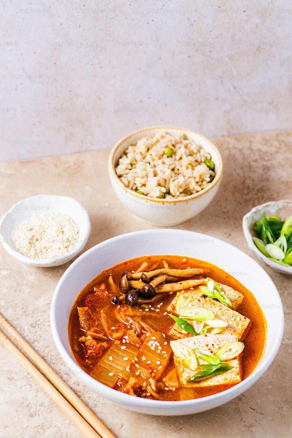 a bowl of food with chopsticks on a table