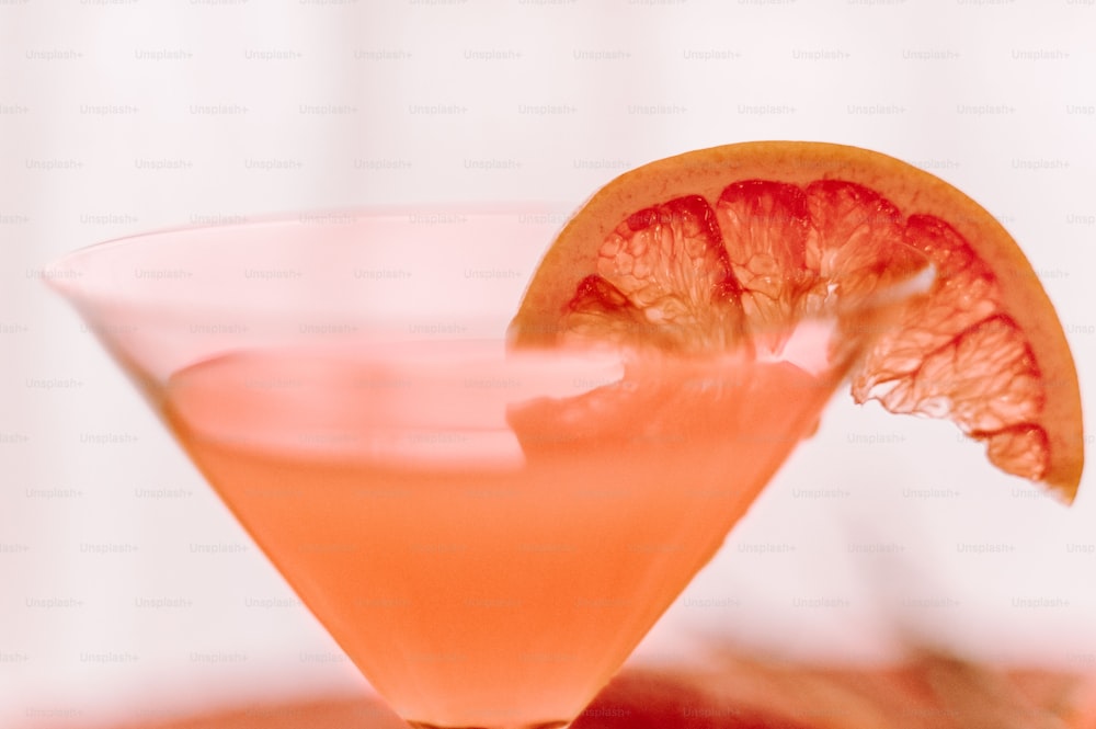 a close up of a drink with a slice of orange