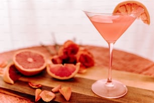 a grapefruit martini garnished with a slice of grapefruit