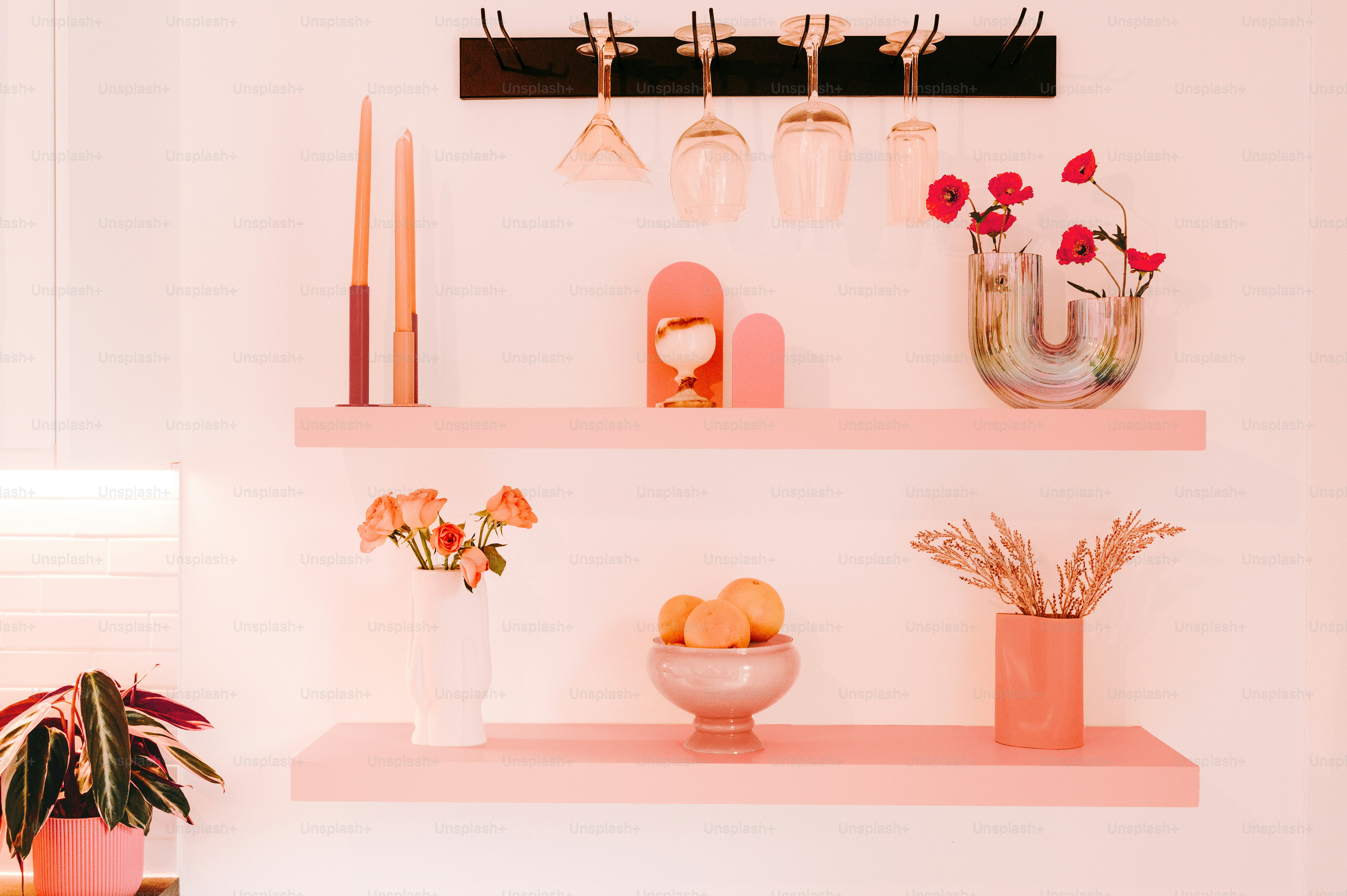 a shelf filled with vases and other items on top of a wall