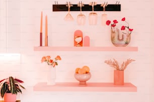 a shelf filled with vases and other items on top of a wall
