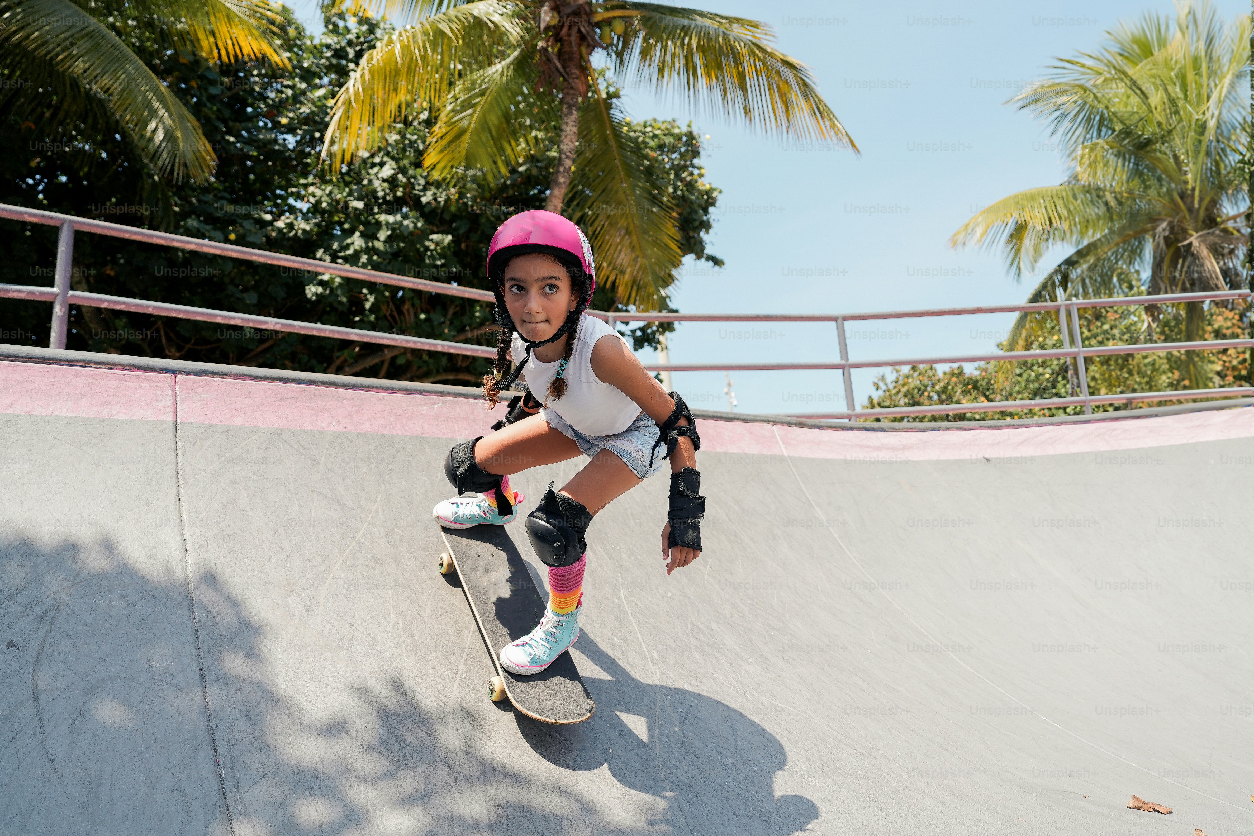 A couple of girls walking down a street with skateboards photo – Tweens  Image on Unsplash