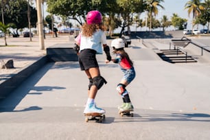a woman teaching a little girl how to skate