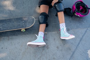 a skateboarder's feet with knee pads and knee pads