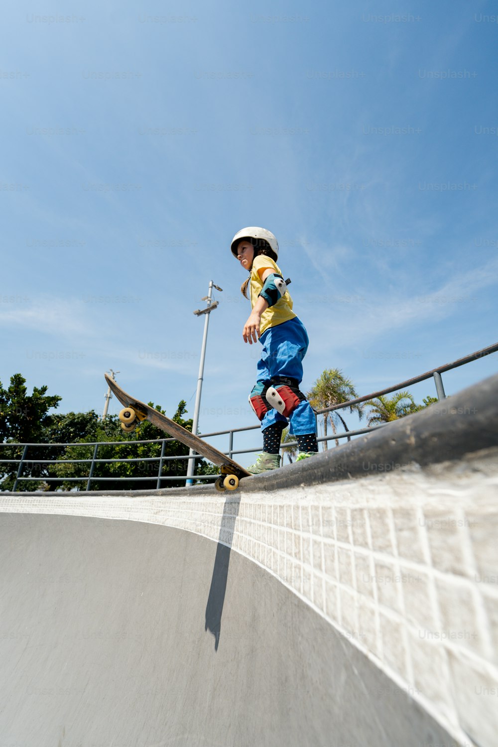 a young boy riding a skateboard up the side of a ramp