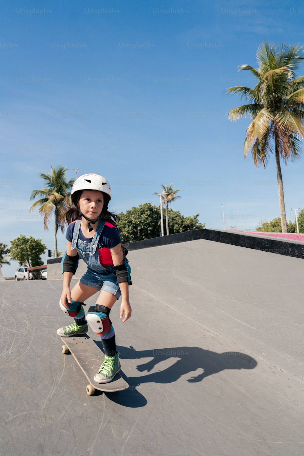 a young boy riding a skateboard down a ramp