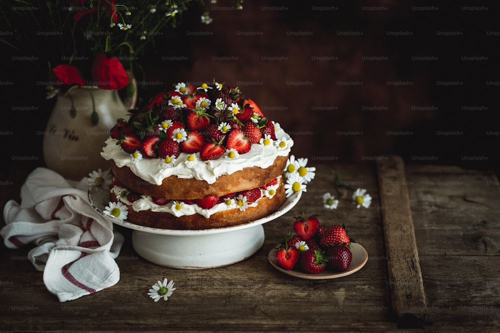 a cake with white frosting and strawberries on top