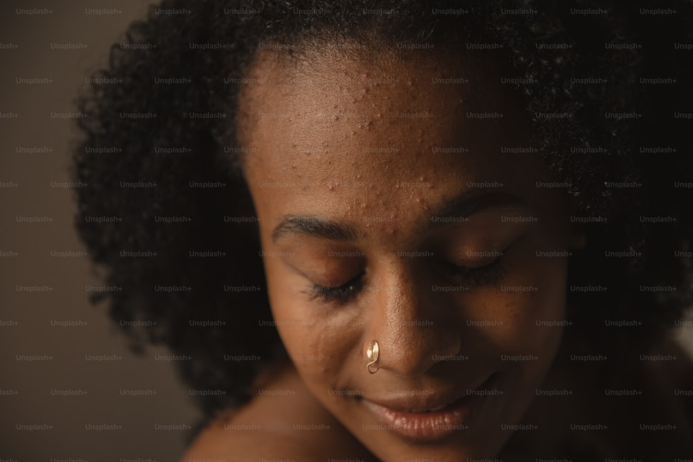 a close up of a woman with a nose piercing