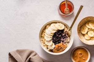 a bowl of oatmeal with bananas and peanut butter