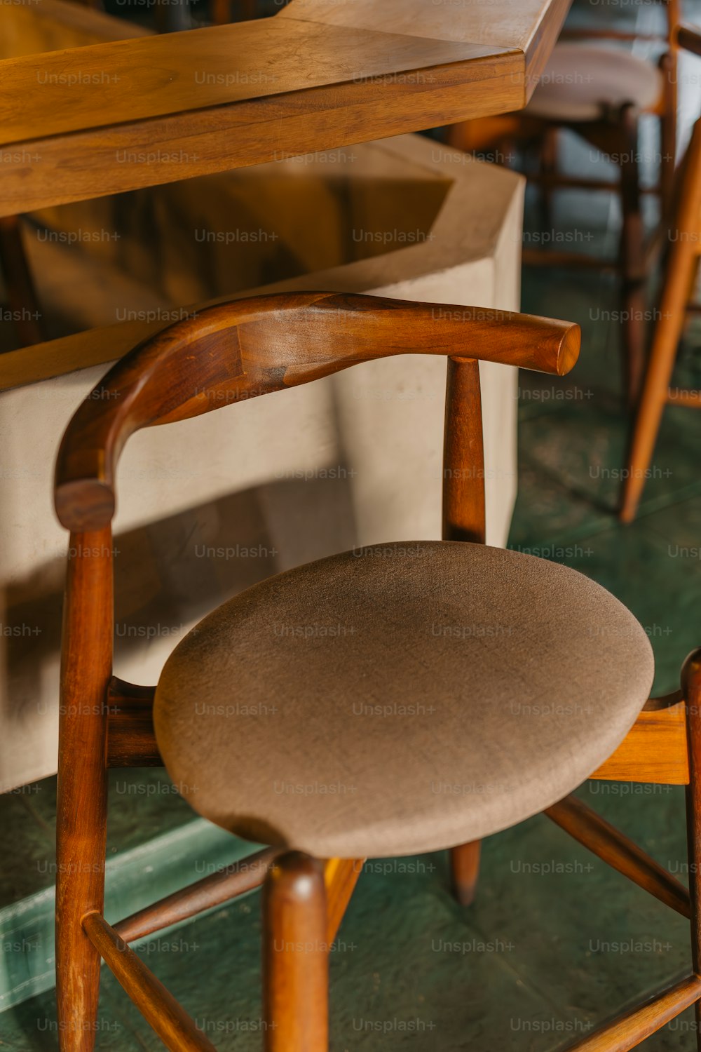 a wooden chair with a brown seat and back rest