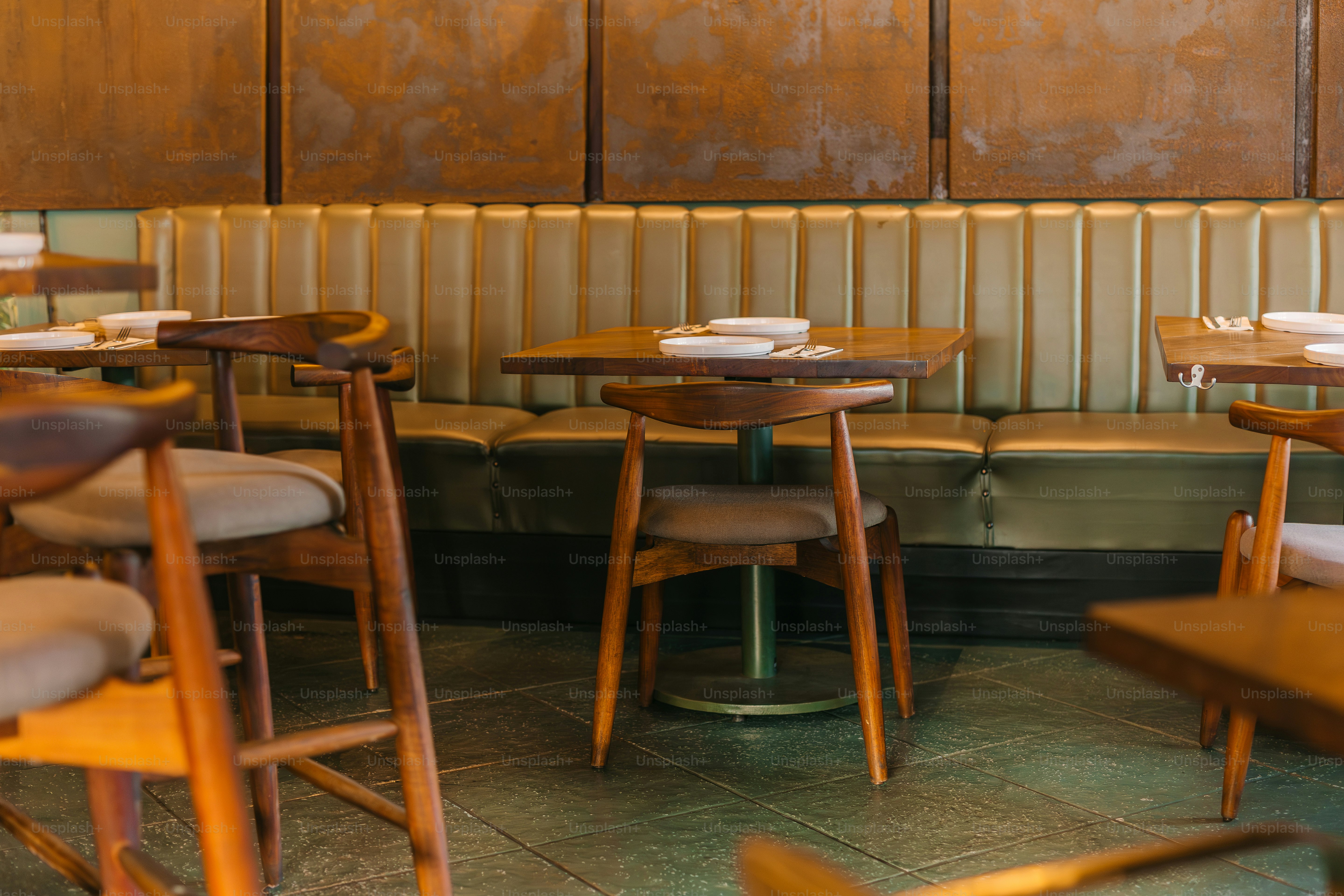 a row of wooden tables and chairs in a restaurant