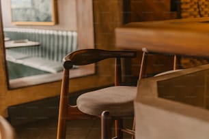 a wooden chair sitting in front of a window