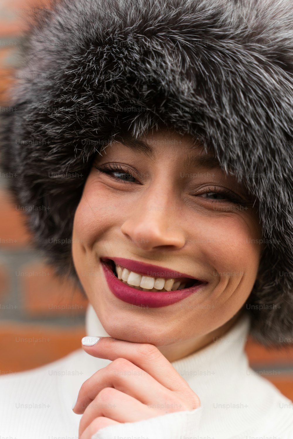 a woman wearing a fur hat and smiling