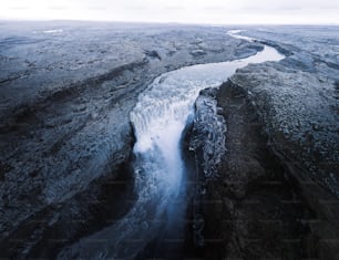 an aerial view of a river running through a rocky landscape