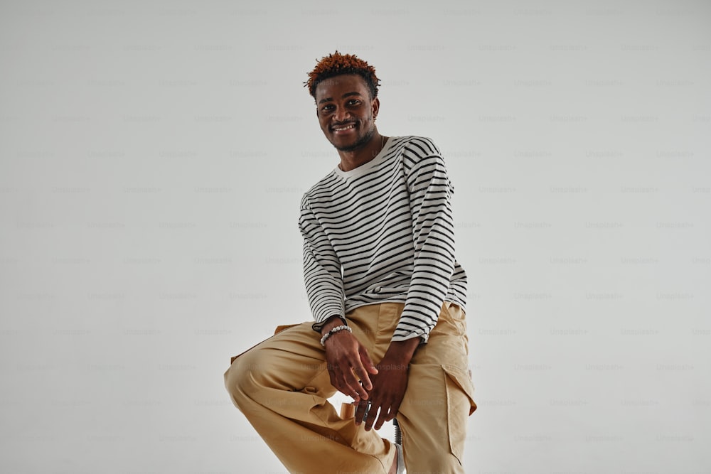 a man in a striped shirt and khaki pants