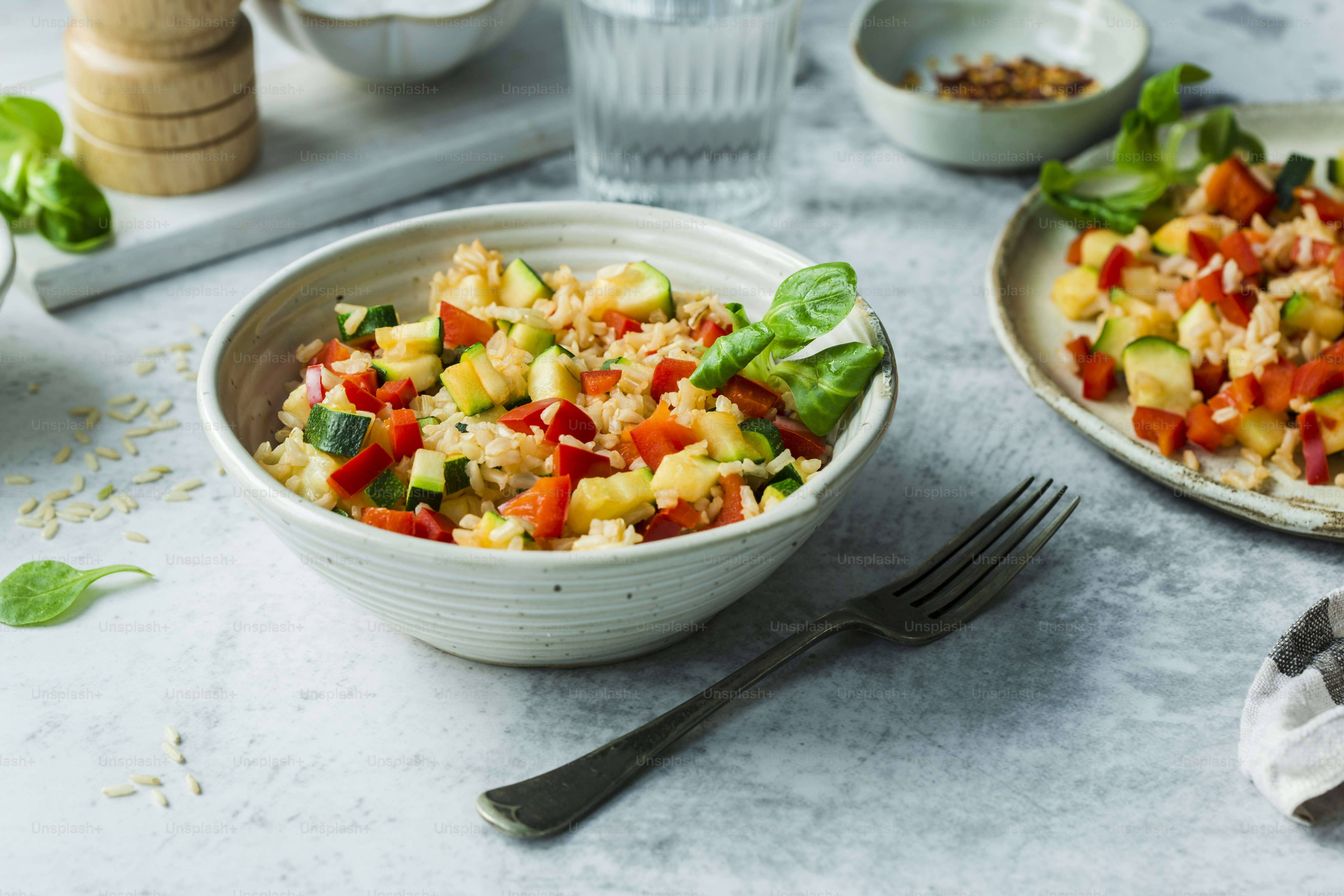 a bowl of food on a table with a fork