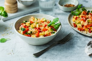 a bowl of food on a table with a fork