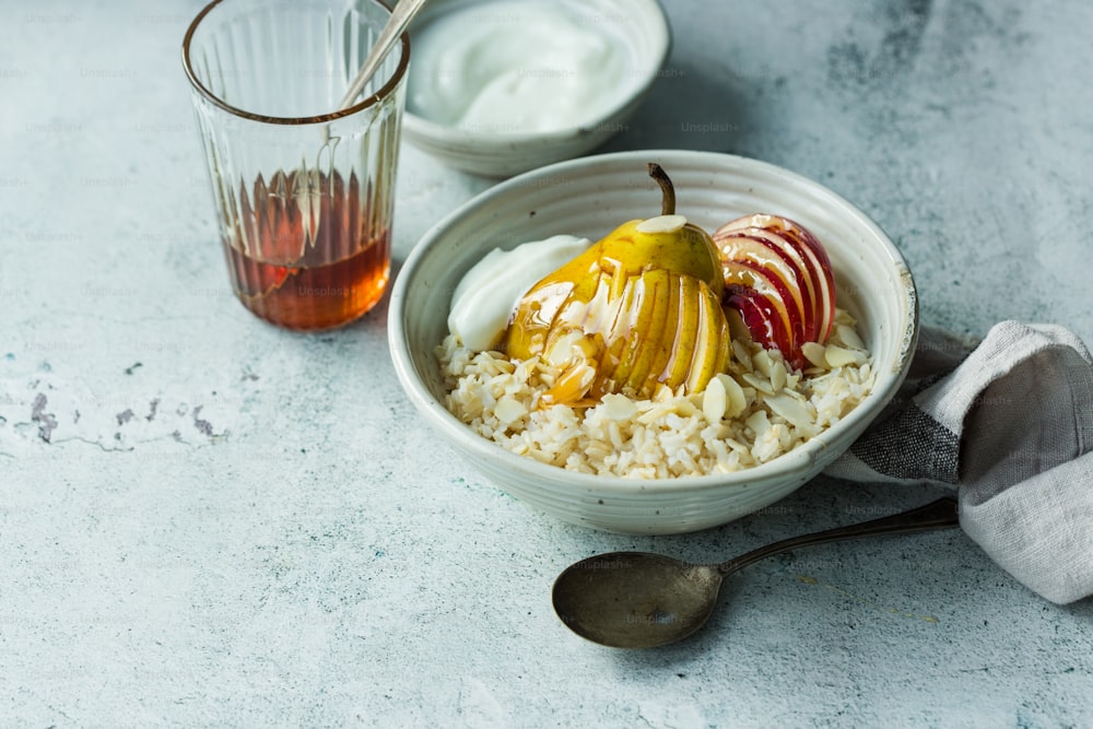 a bowl of oatmeal with apples and yogurt