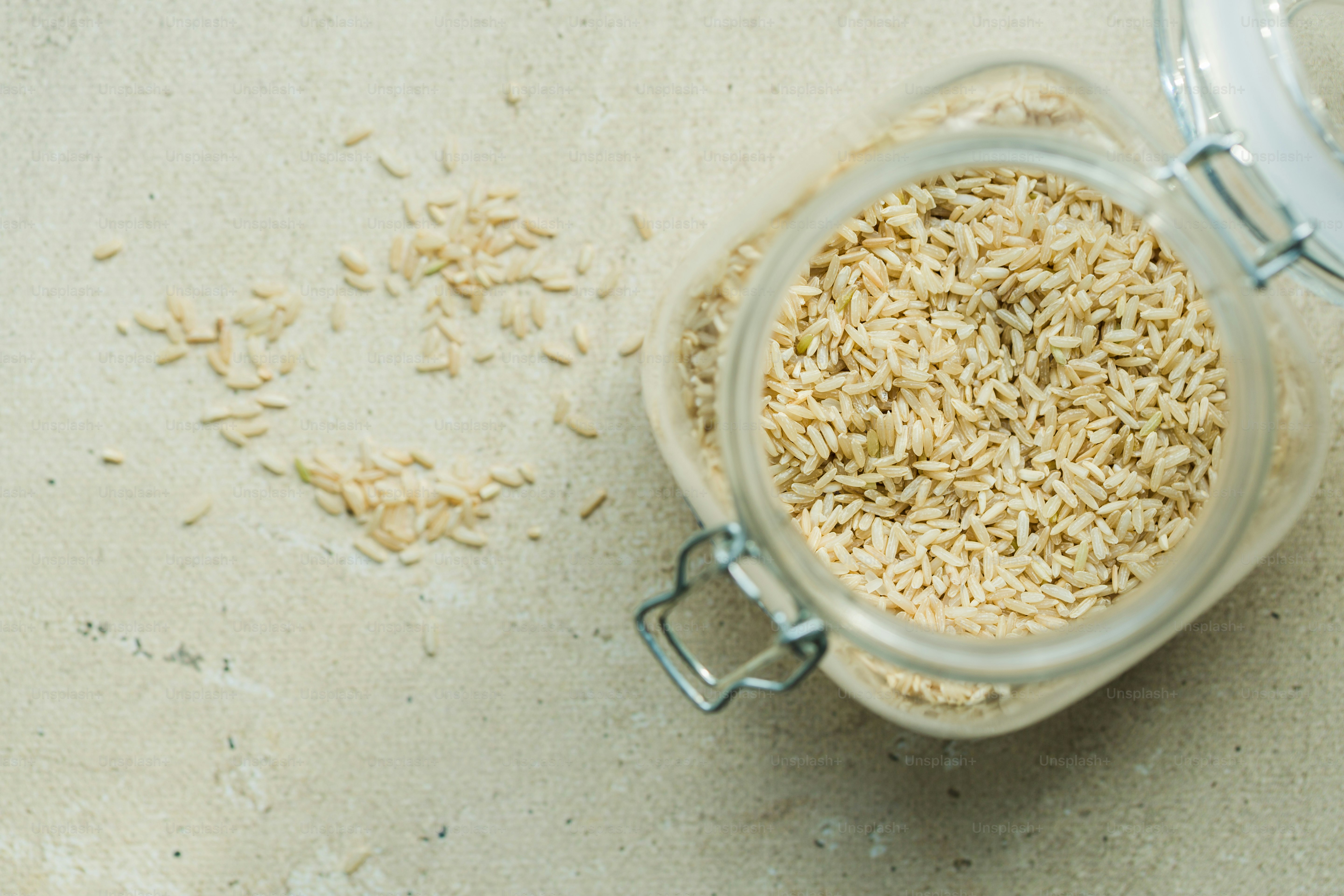 a glass jar filled with rice on top of a table