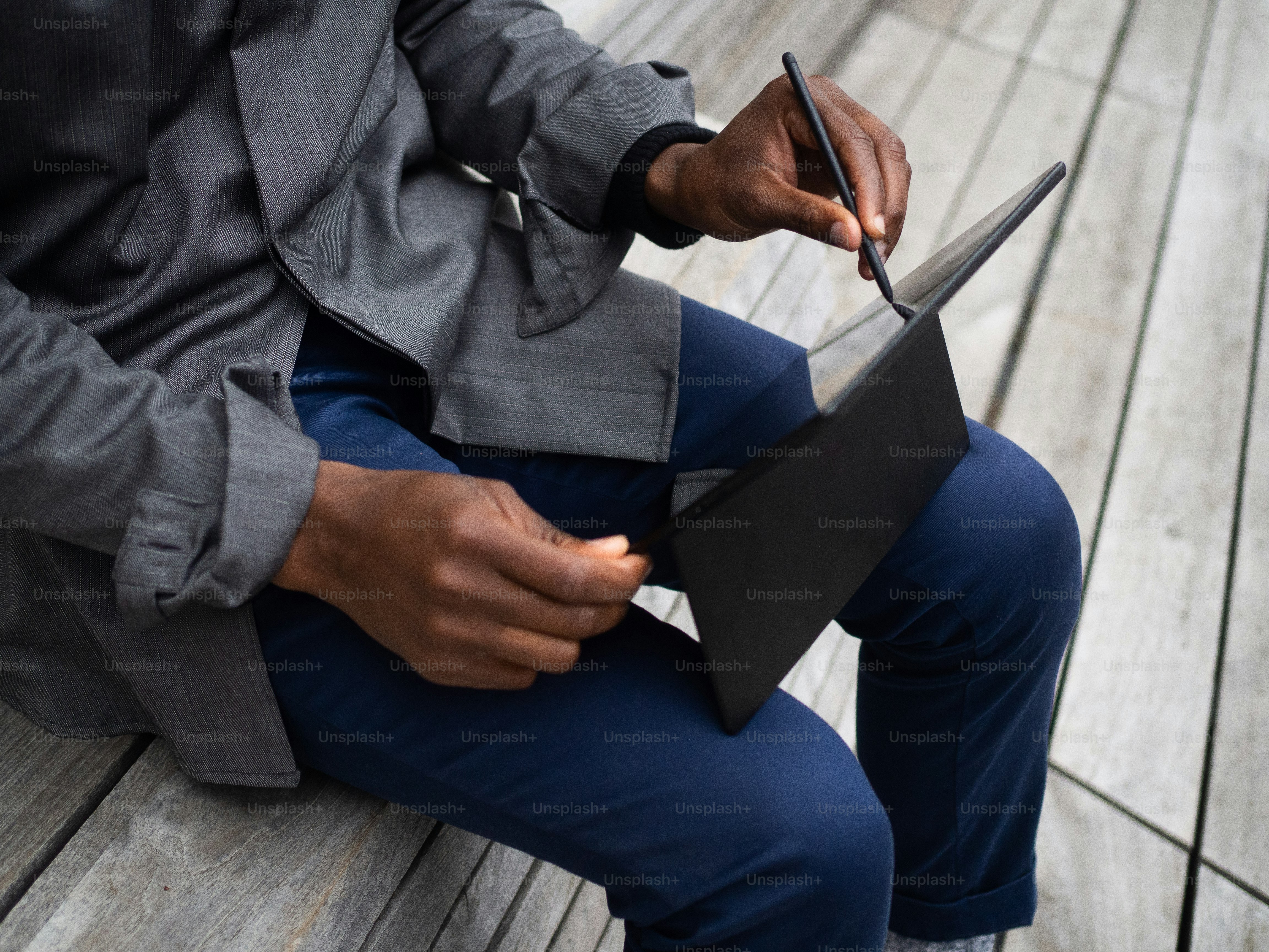 una persona sentada en un banco con una computadora portátil