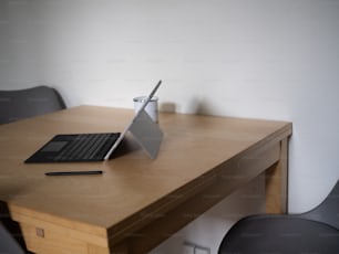 a laptop computer sitting on top of a wooden desk