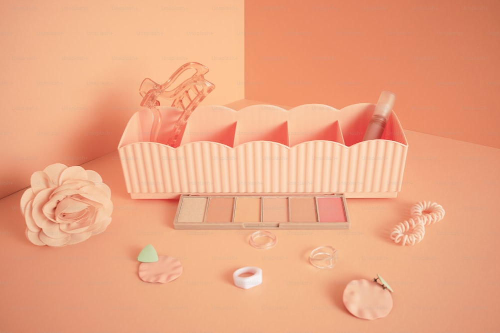 a set of cosmetics and a flower on a table