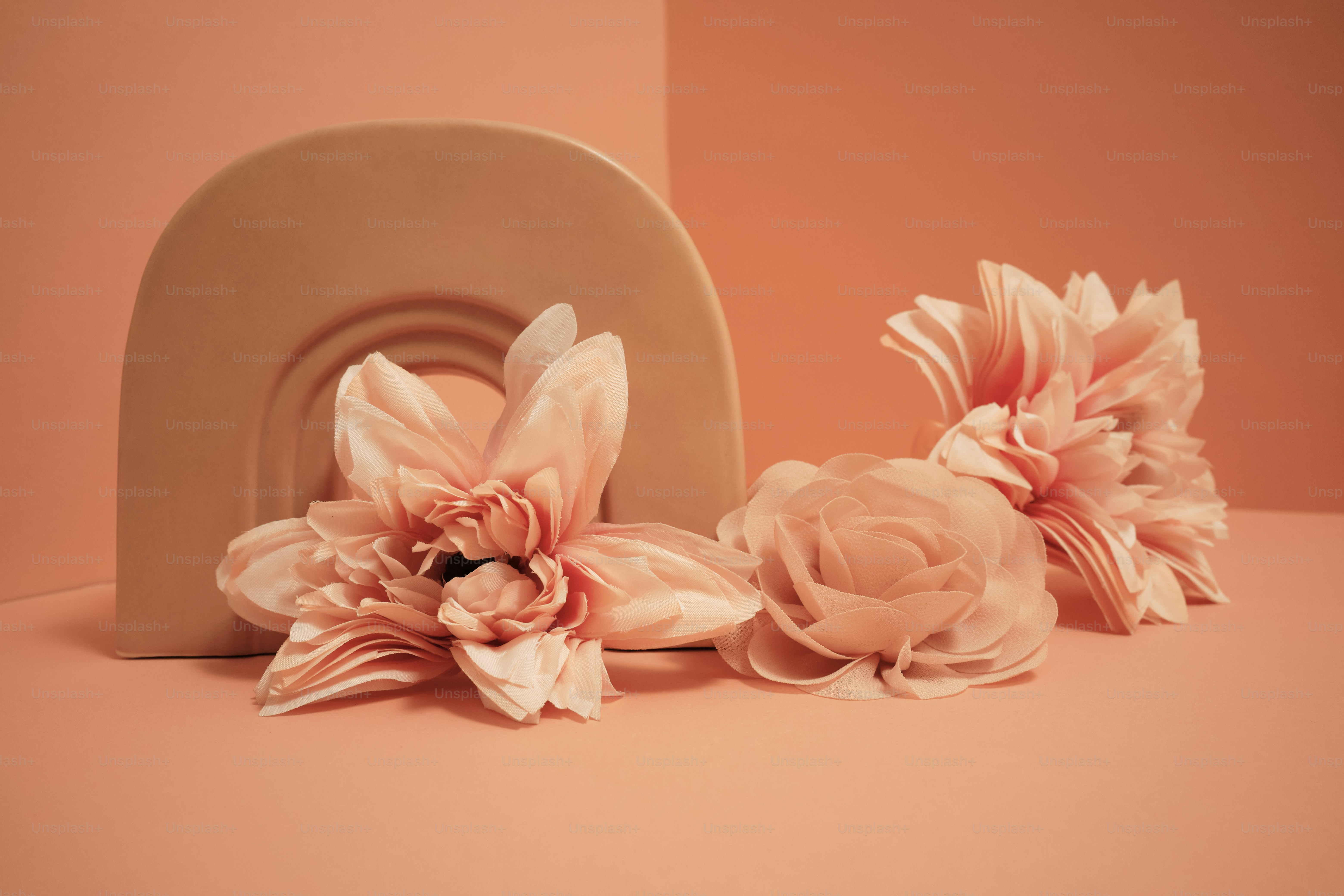 a group of pink flowers sitting on top of a table