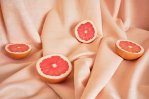 a grapefruit cut in half sitting on a bed
