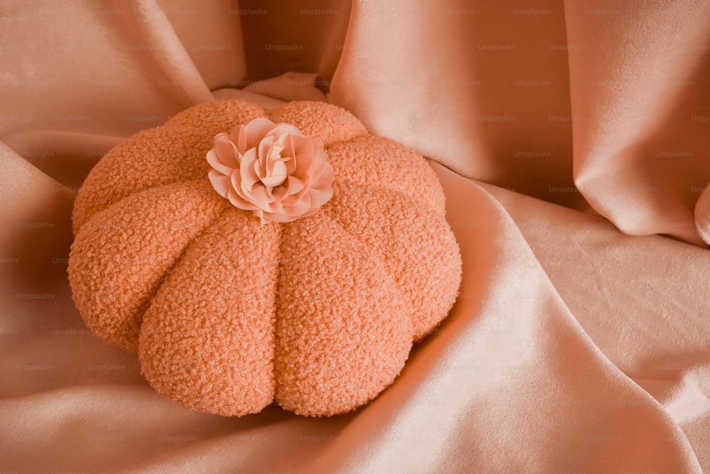 a decorative pumpkin shaped pillow on a bed