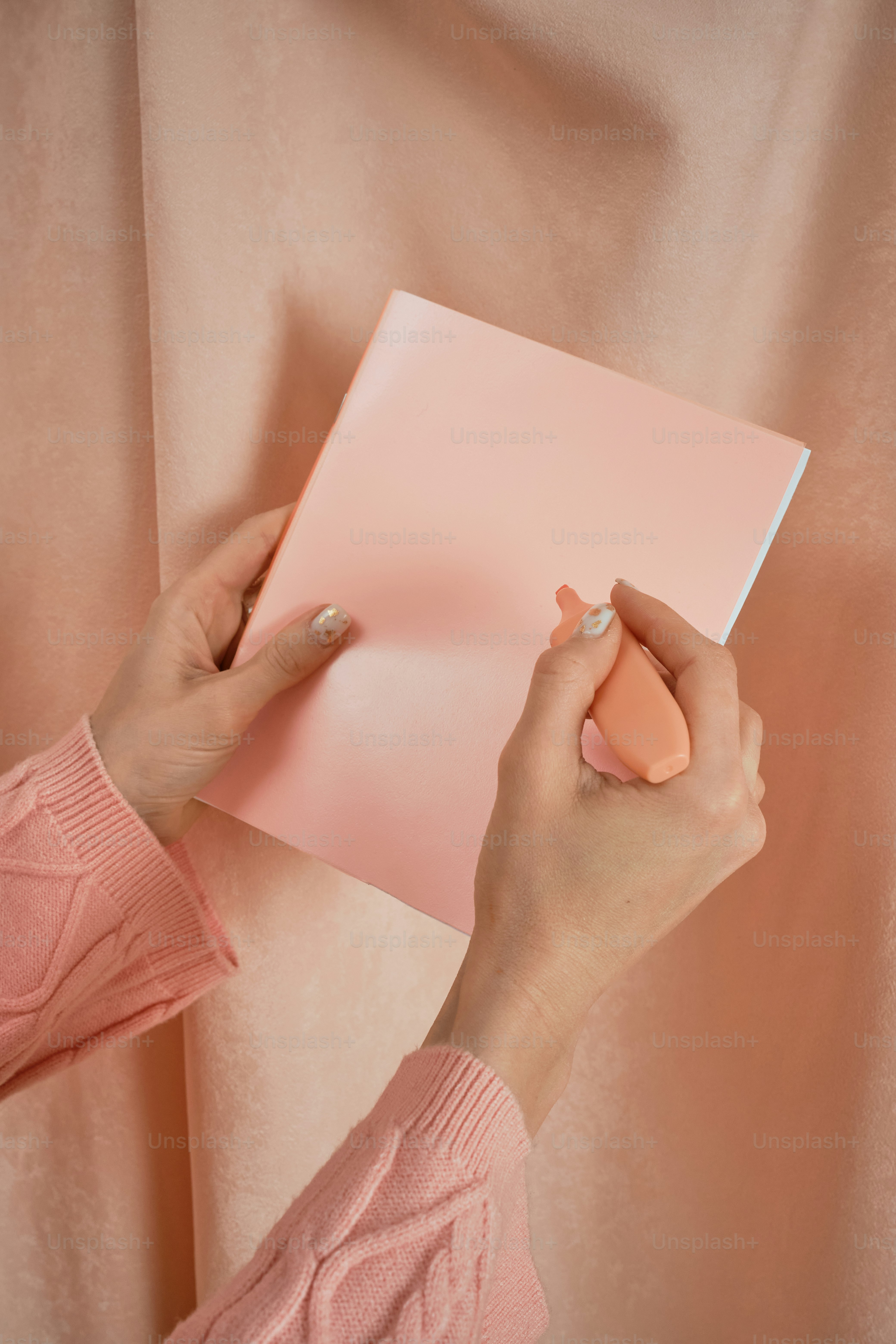 a woman is holding a book and a mouse