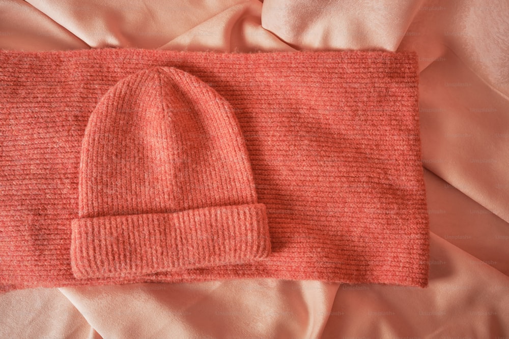 a red hat laying on top of a bed