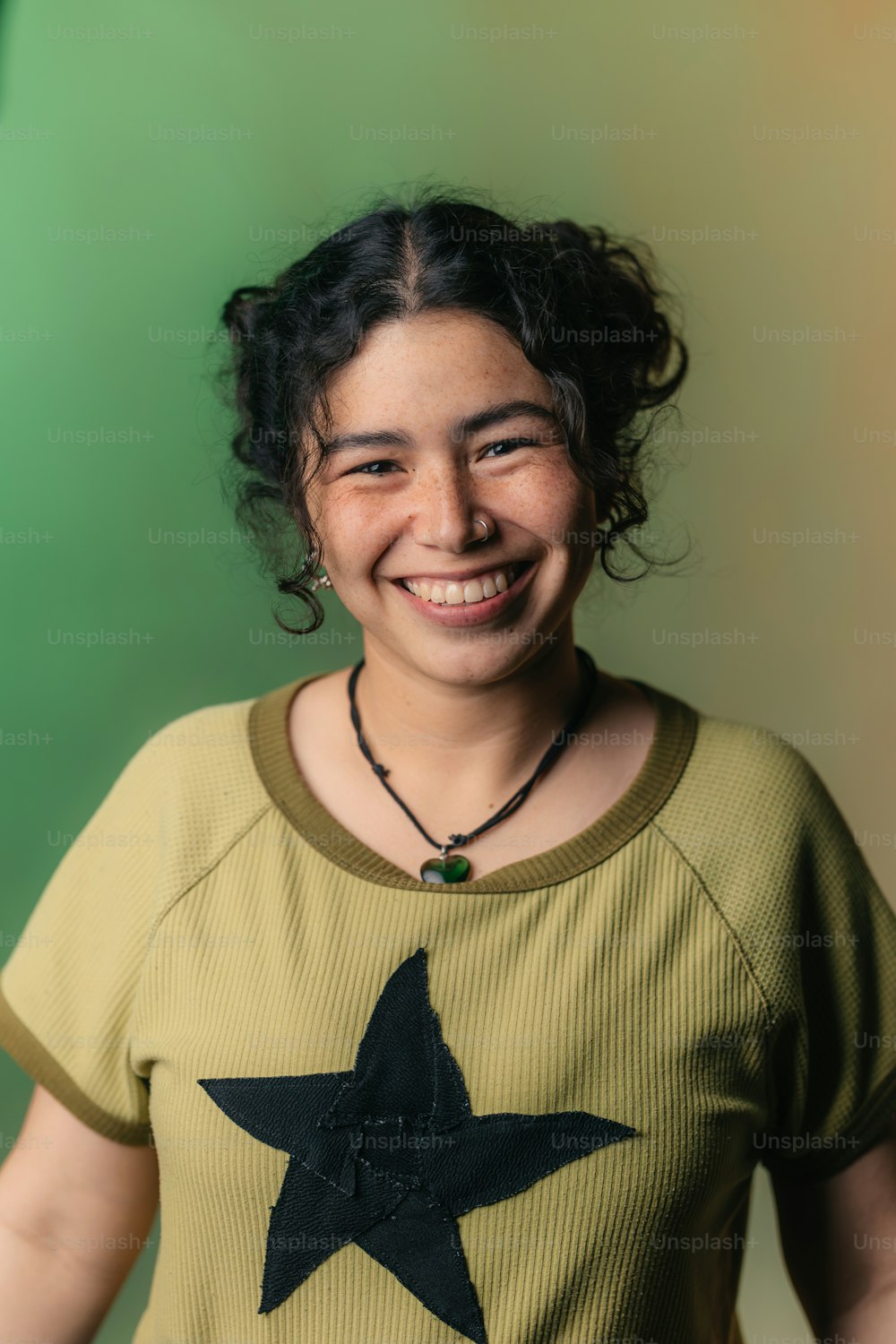 a smiling woman with a star on her shirt