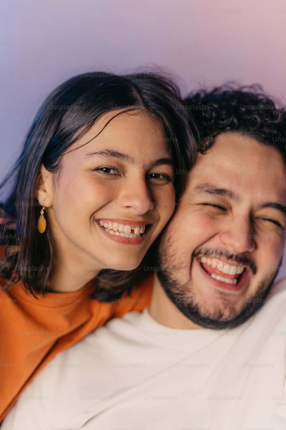 a man and a woman are smiling for the camera