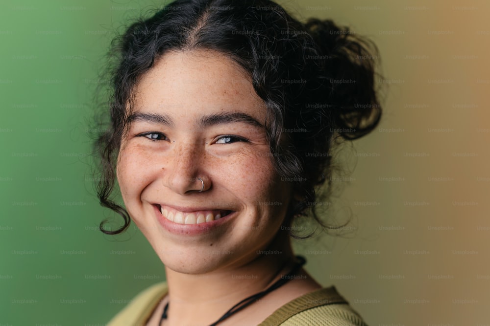 a woman with curly hair smiling at the camera