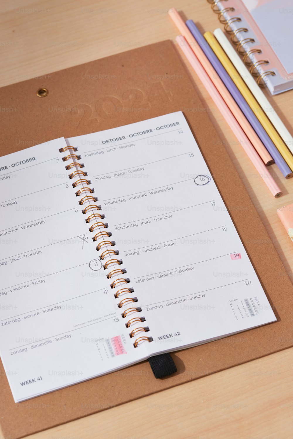 a notepad with a spiral bound notebook on top of a wooden table
