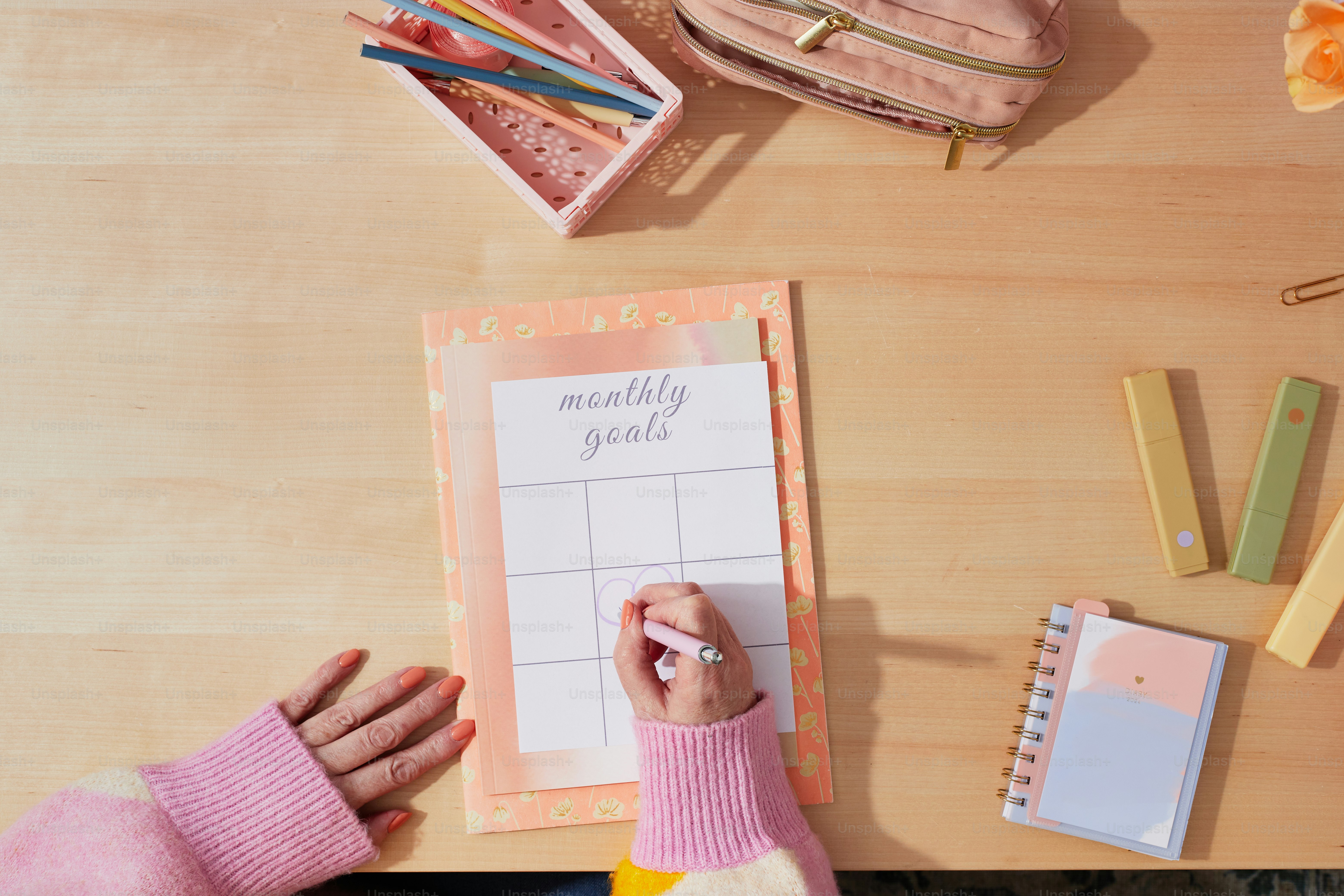 a person writing on a calendar on a table