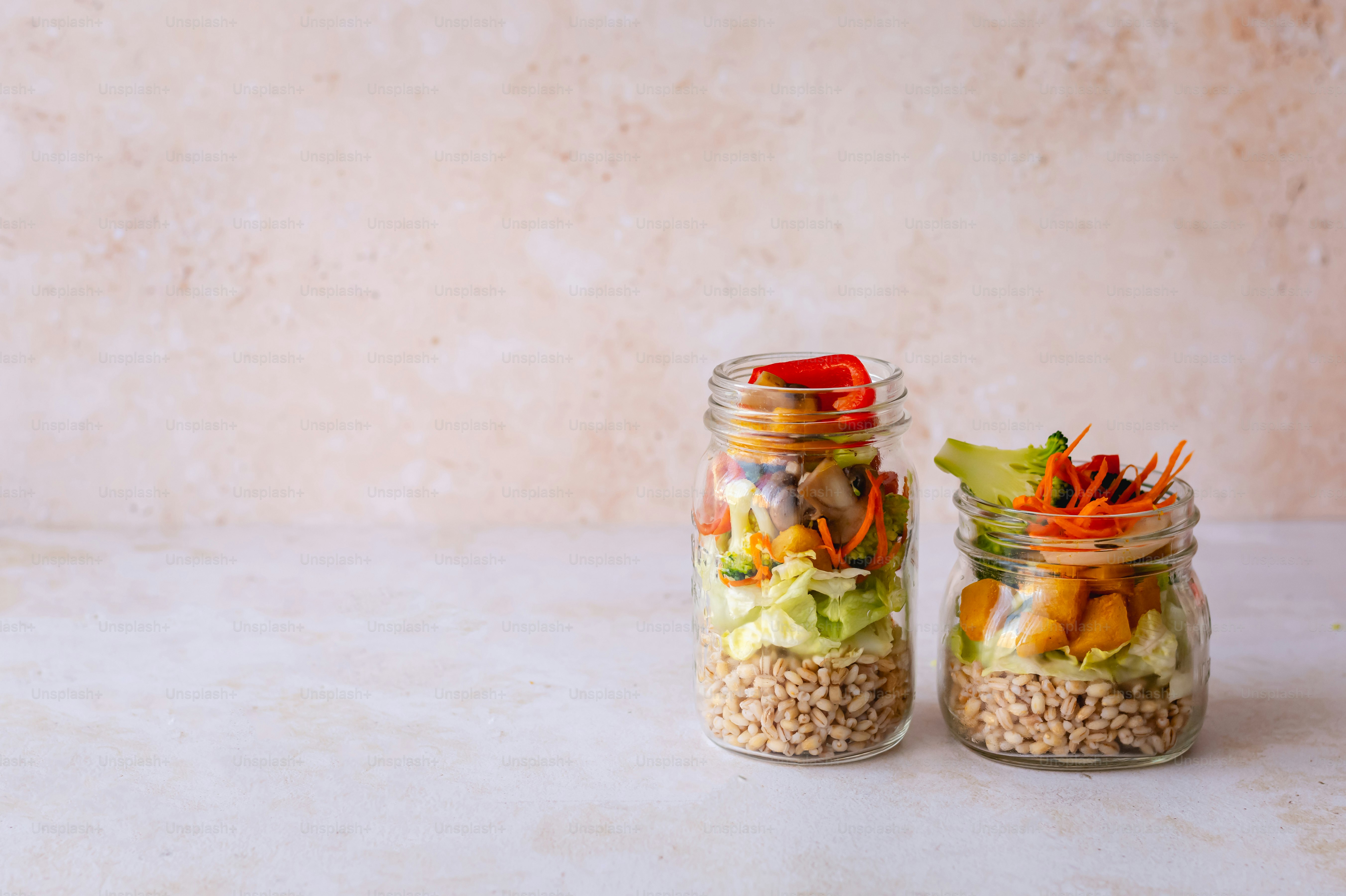 a couple of jars filled with food on top of a table