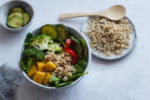 a bowl filled with rice, broccoli, and other vegetables