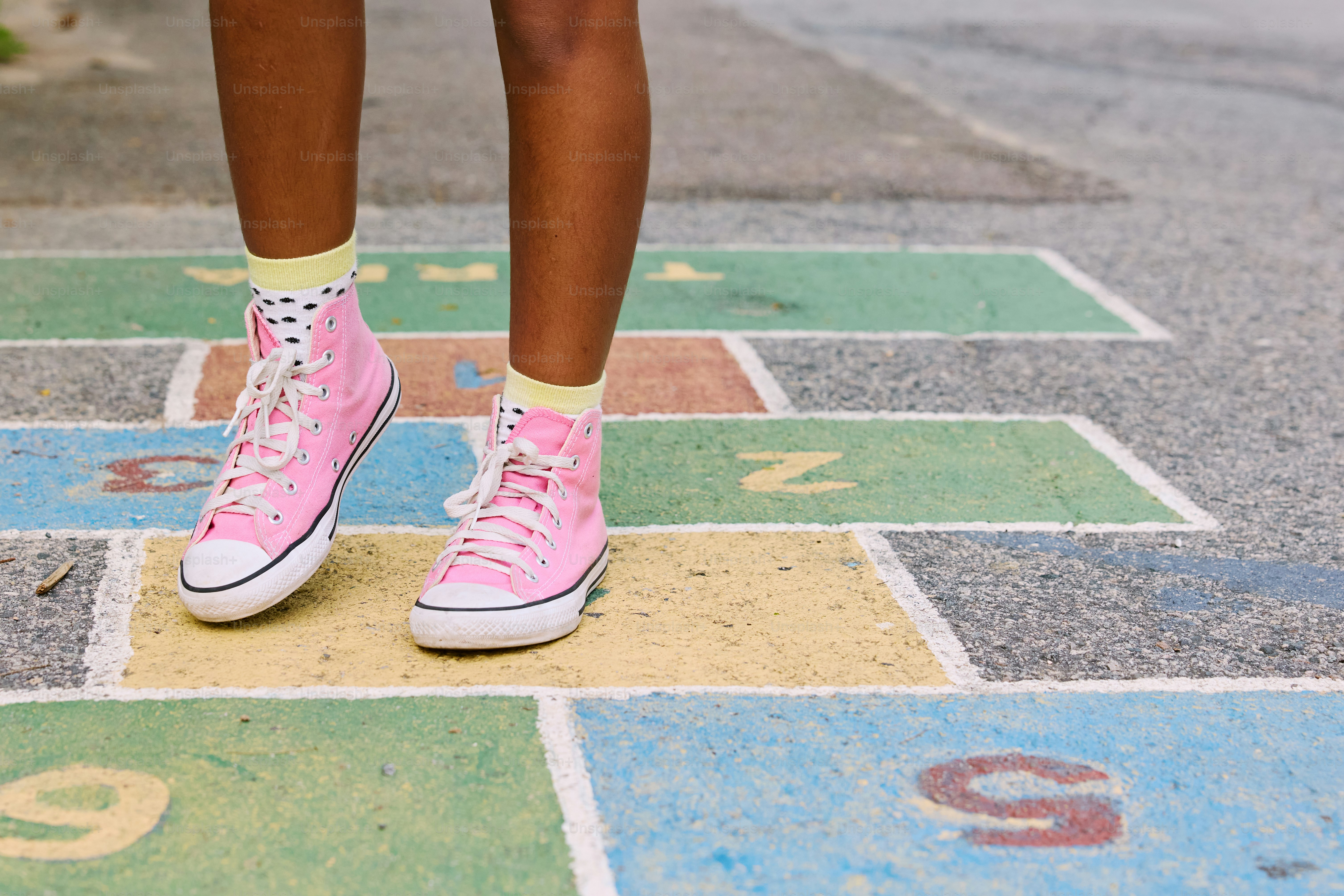 a person in pink sneakers standing on a hoppy hoppy hoppy hoppy