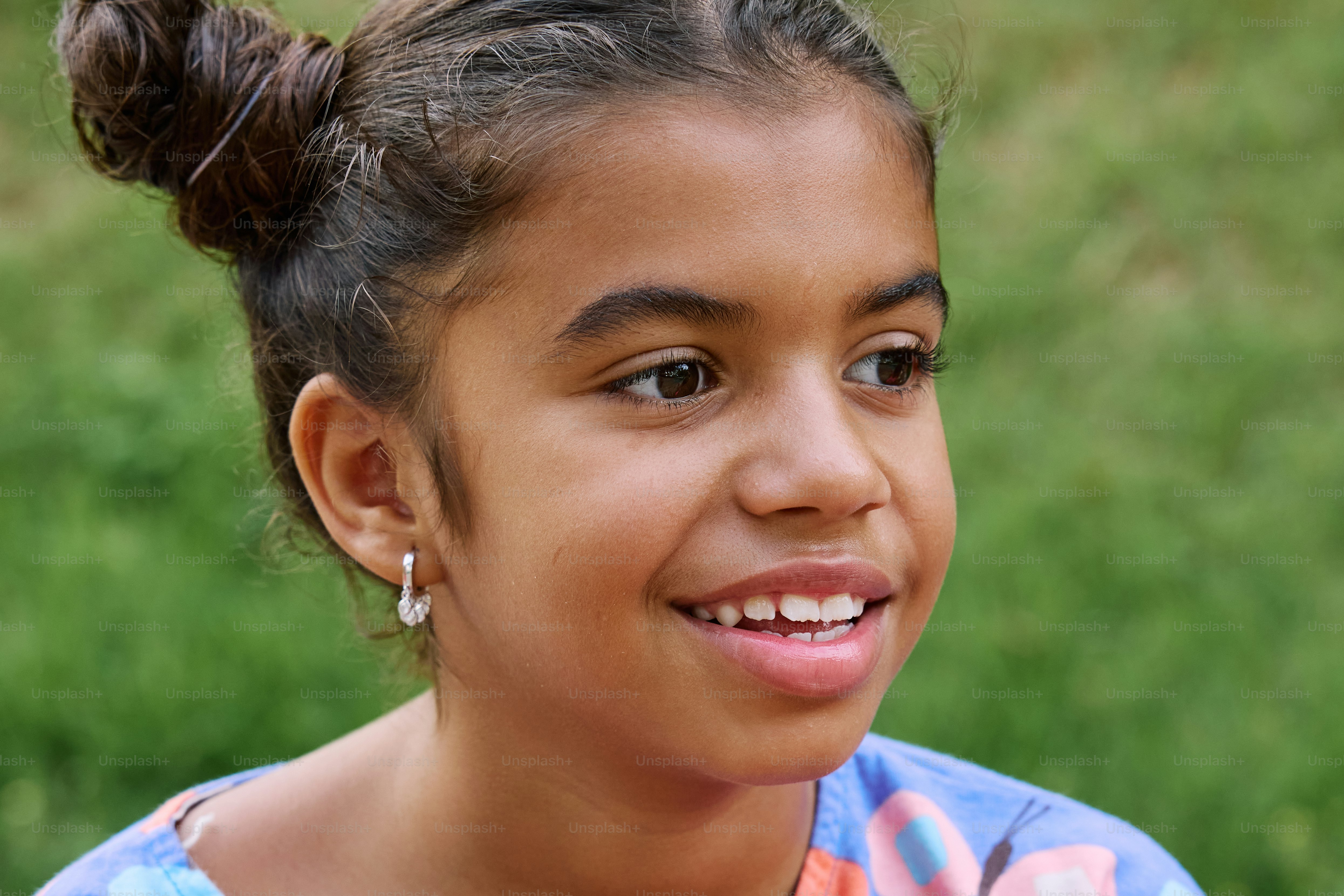 a young girl with a bun in her hair
