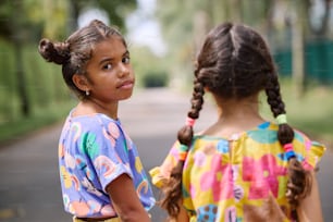 two little girls standing next to each other