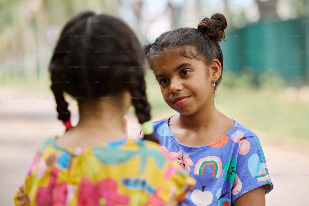 two little girls standing next to each other